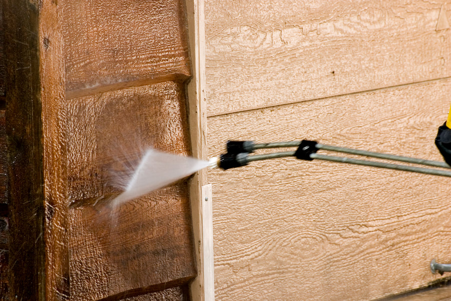 a fire hydrant spraying water on a wooden building